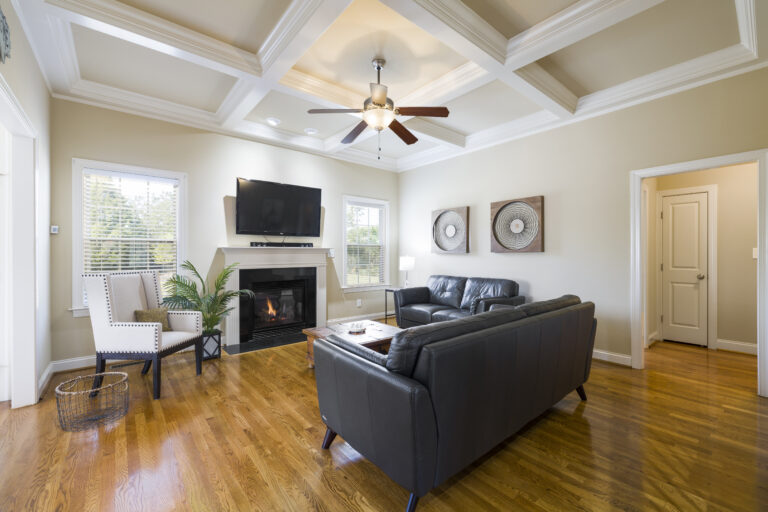 Photo of a living room with a ceiling fan.